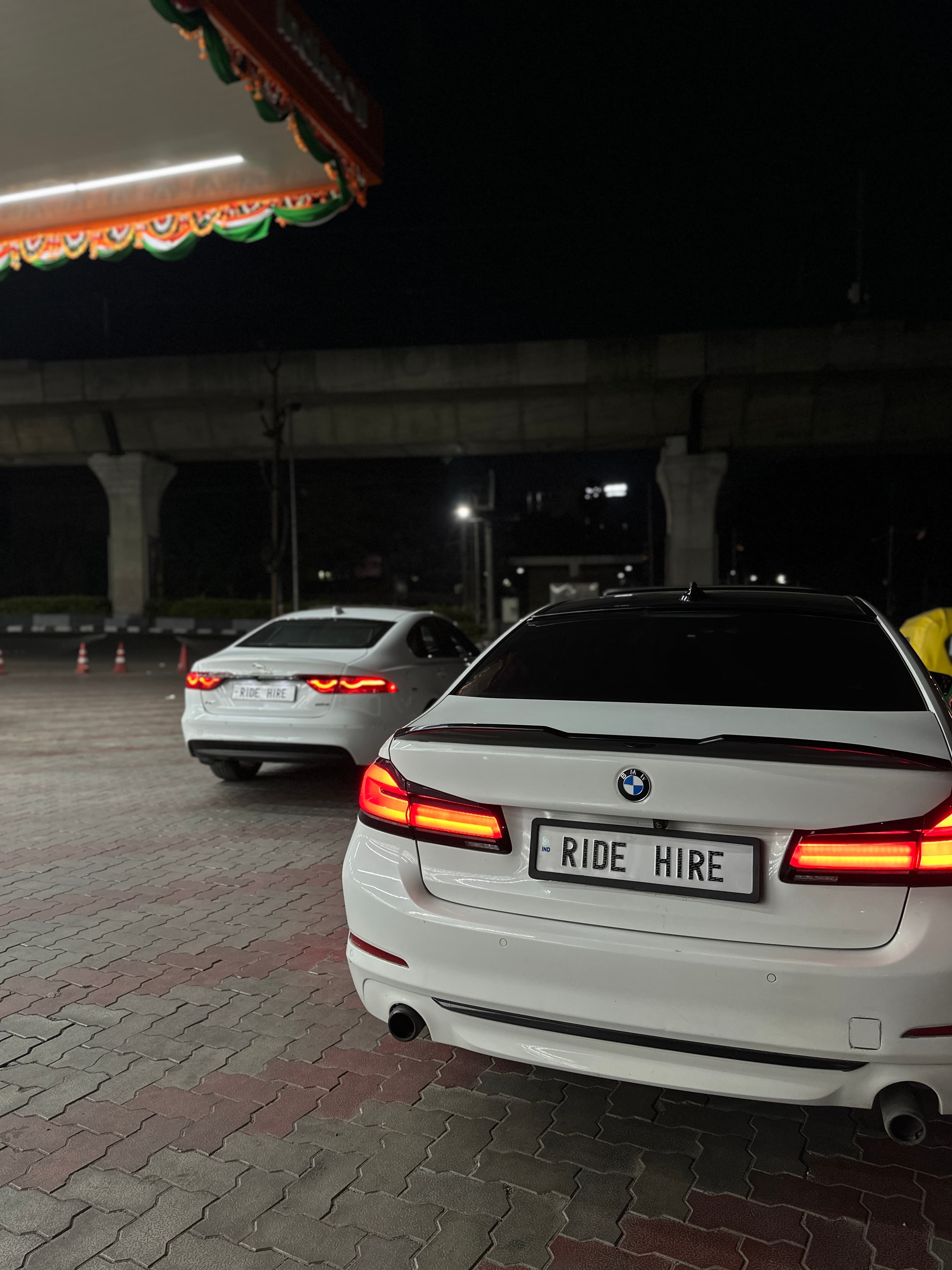 Ridehire BMW 5 Series with RIDE HIRE plate at night